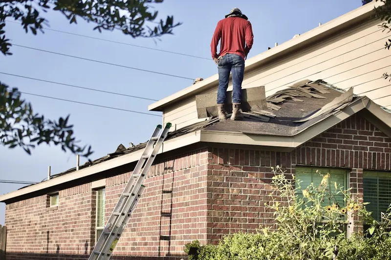 Professional roofer working on a residential roof in Saint Lucie